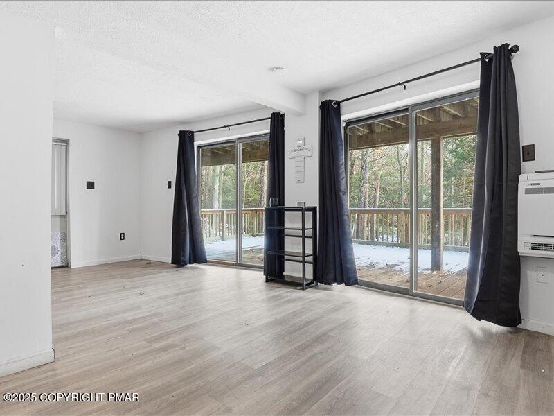 2167 Freedom Way Pocono Summit, PA 18346 - Photo 35 of 45 a view of an empty room with wooden floor and a window
