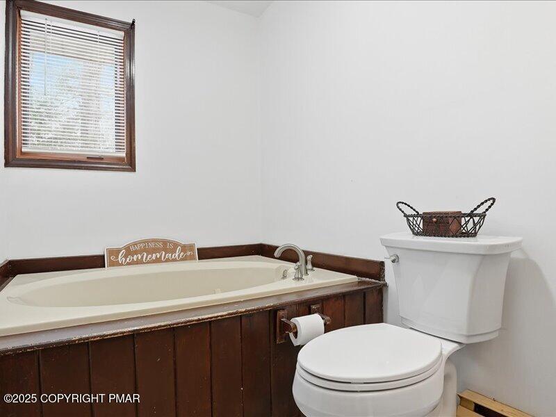 2167 Freedom Way Pocono Summit, PA 18346 - Photo 36 of 45 a bathroom with a sink a toilet and vanity