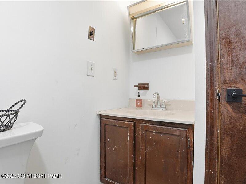 2167 Freedom Way Pocono Summit, PA 18346 - Photo 37 of 45 a bathroom with a sink a toilet and mirror