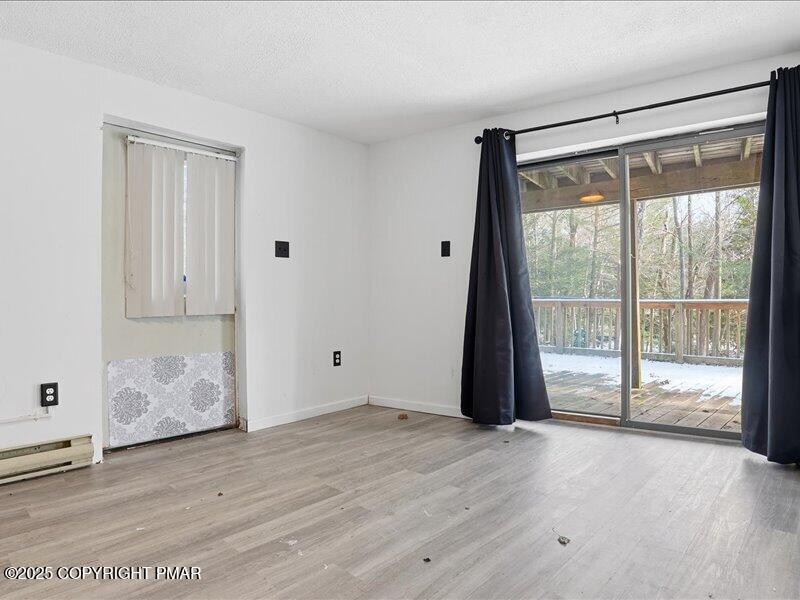 2167 Freedom Way Pocono Summit, PA 18346 - Photo 40 of 45 a view of an empty room with wooden floor and a window