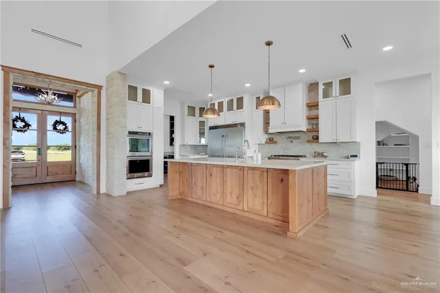 a large kitchen with stainless steel appliances granite countertop a large counter top and a stove