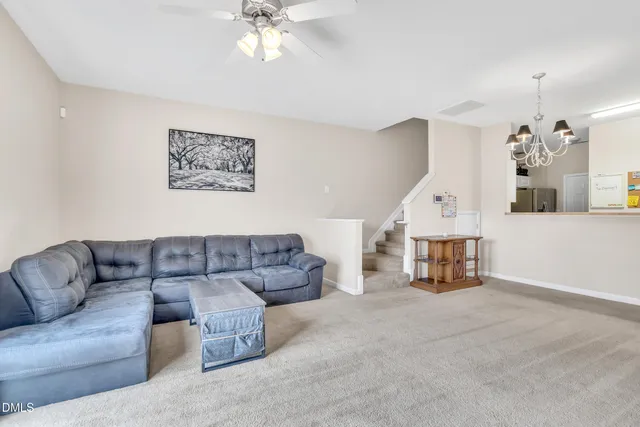 a living room with furniture and a chandelier