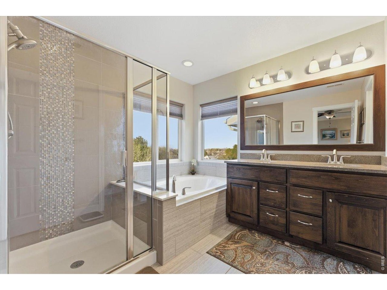 1148 Wagon Bend Road Berthoud, CO 80513 - Photo 31 of 50 a spacious bathroom with a tub sink shower and mirror