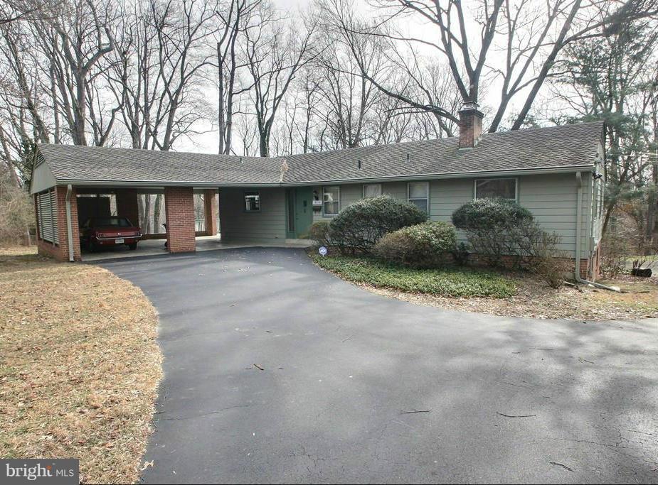 9119 Levelle Drive Chevy Chase, MD 20815 - Photo 1 of 30 a front view of a house with a yard and garage