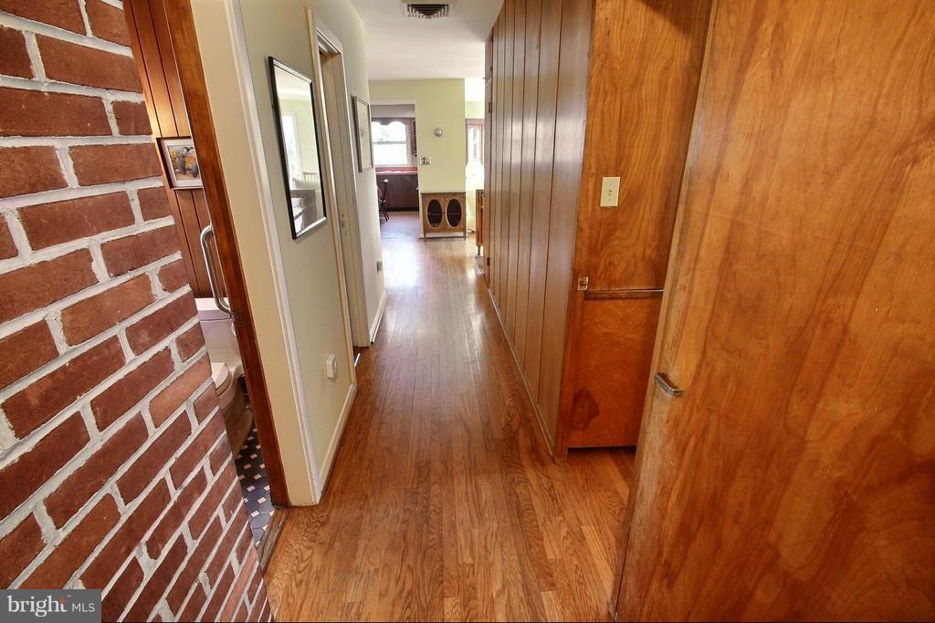 9119 Levelle Drive Chevy Chase, MD 20815 - Photo 14 of 30 a view of a hallway with wooden floor and staircase