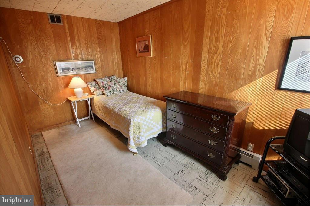 9119 Levelle Drive Chevy Chase, MD 20815 - Photo 23 of 30 a spacious bedroom with a bed and a window