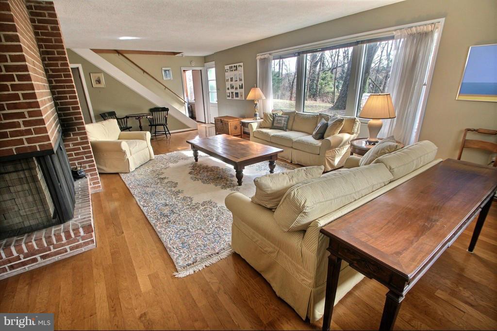 9119 Levelle Drive Chevy Chase, MD 20815 - Photo 26 of 30 a living room with furniture and a floor to ceiling window