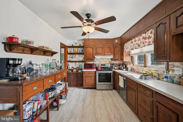 a kitchen with stainless steel appliances kitchen island granite countertop lots of counter top space