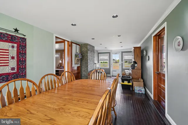 a dining room with furniture and wooden floor