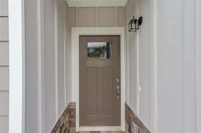 a view of a hallway with wooden floor and closet