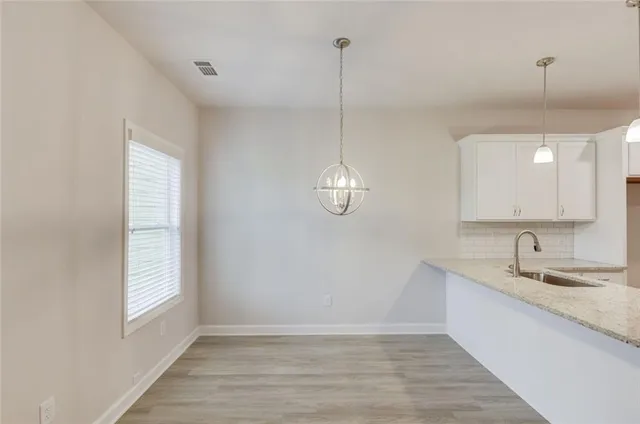a kitchen with stainless steel appliances granite countertop a sink a stove and a granite counter top