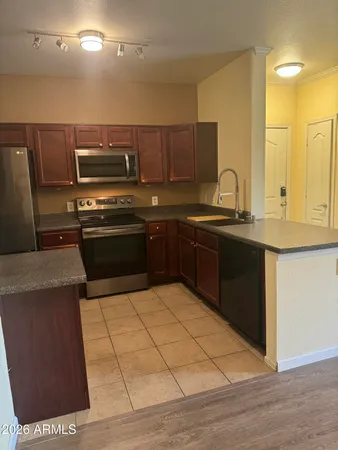 a kitchen with granite countertop a refrigerator and a stove