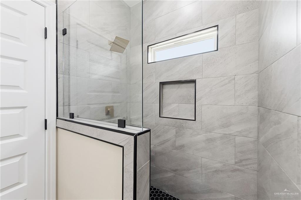 18032 Spruce Street Combes, TX 78552 - Photo 12 of 14 a bathroom with a shower and a sink