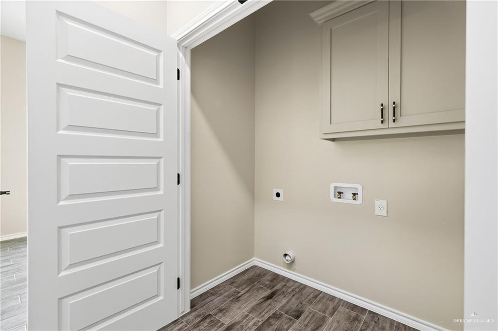 18032 Spruce Street Combes, TX 78552 - Photo 13 of 14 a view of walk in closet with empty racks
