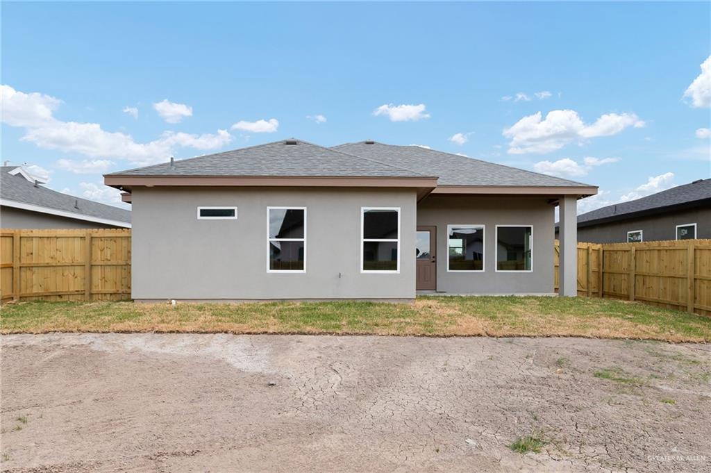 18032 Spruce Street Combes, TX 78552 - Photo 14 of 14 a view of a house with a backyard and garage