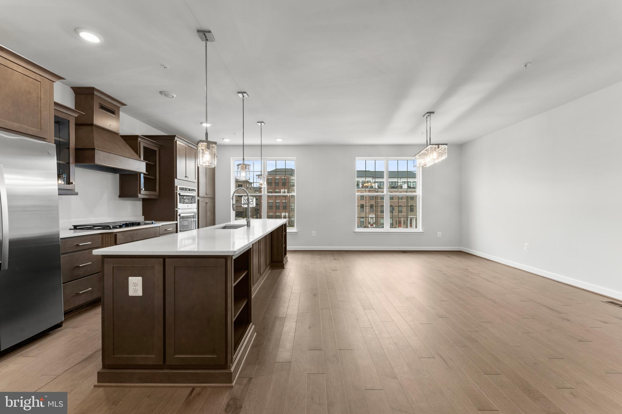 608 Catamaran Way National Harbor, MD 20745 - Photo 12 of 30 a kitchen with kitchen island granite countertop a sink a counter top space stainless steel appliances and a window