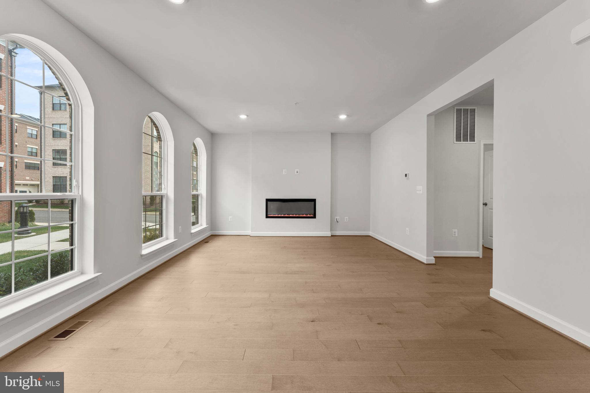 608 Catamaran Way National Harbor, MD 20745 - Photo 3 of 30 a view of an empty room with a fireplace and a window