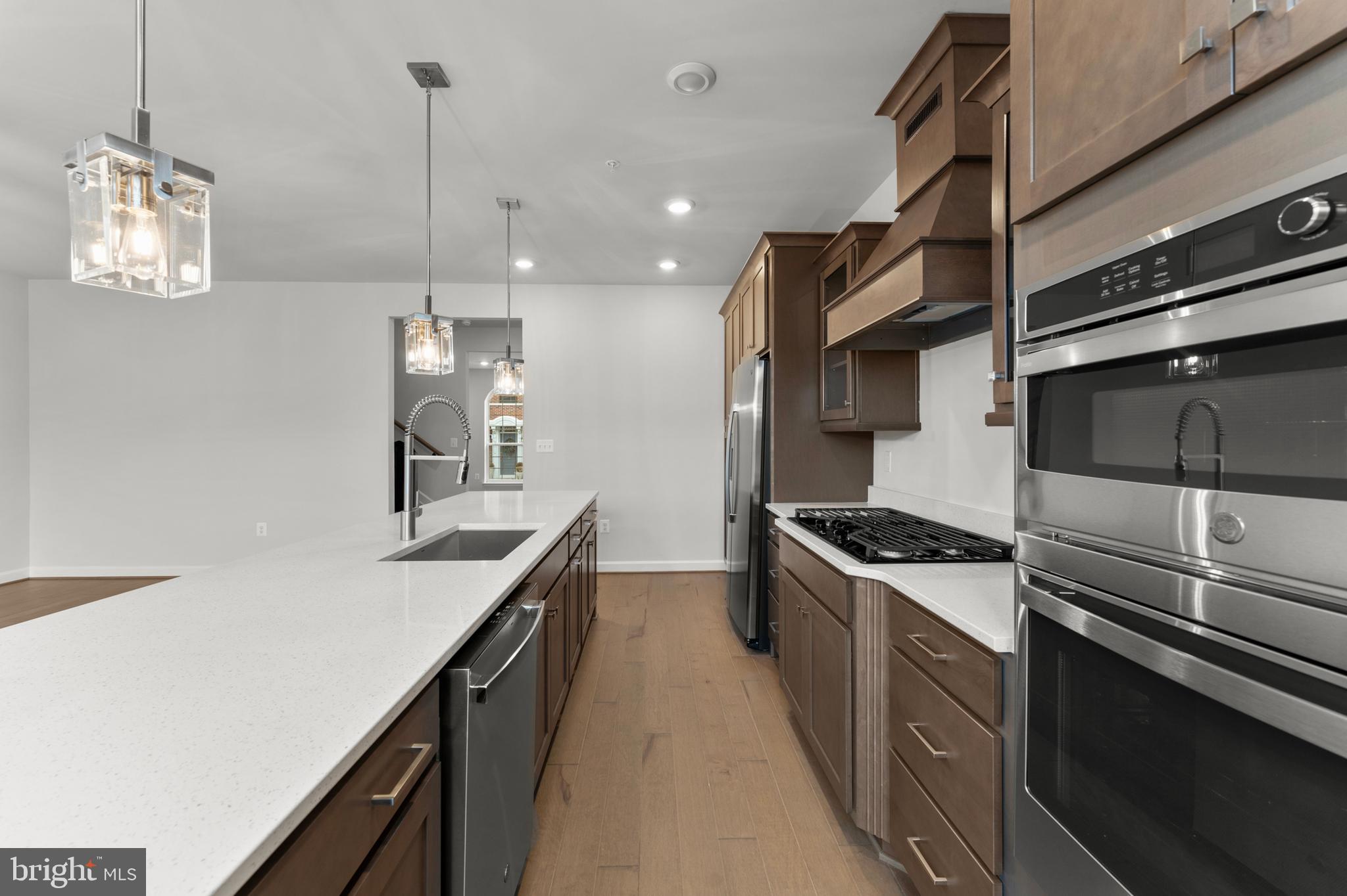 608 Catamaran Way National Harbor, MD 20745 - Photo 9 of 30 a kitchen with stainless steel appliances granite countertop a sink a stove and a refrigerator