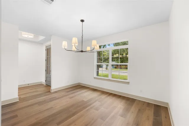 a large kitchen with a large counter top a sink stainless steel appliances and cabinets