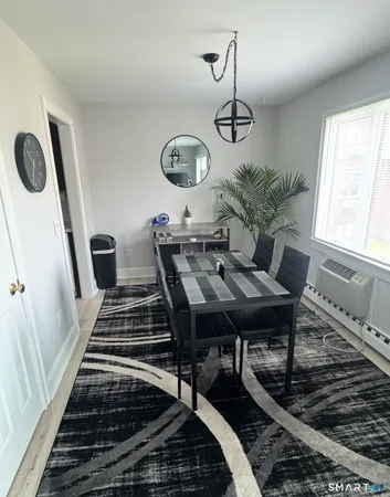 a view of a dining room and hall with furniture