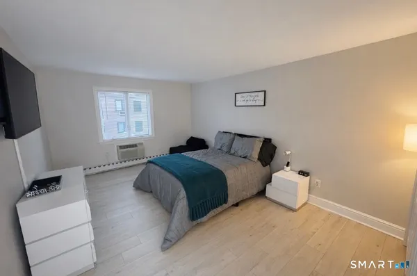 a bedroom with a bed and a flat screen tv