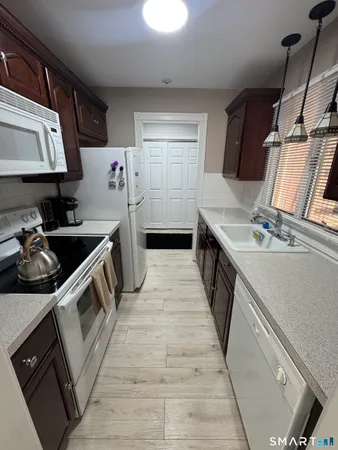 a kitchen with stainless steel appliances granite countertop a sink and cabinets