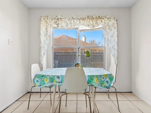 a view of a dining room with furniture and a window