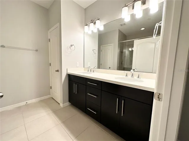 a bathroom with a double vanity sink mirror and double