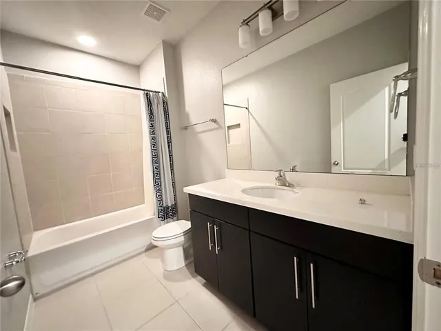 a bathroom with a double vanity sink toilet and shower
