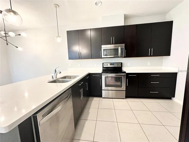 a kitchen with a sink a stove and refrigerator