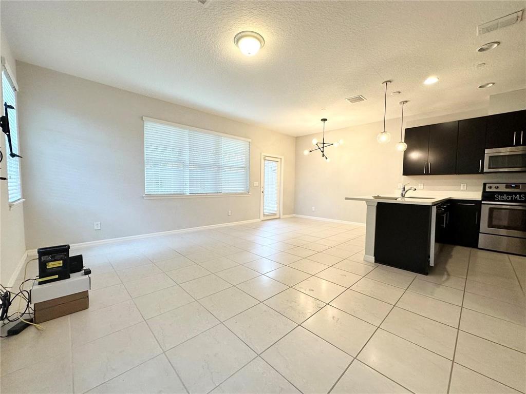 122 Zamora Place Oviedo, FL 32765 - Photo 6 of 23 a large kitchen with stainless steel appliances a stove a sink a counter top space and cabinets