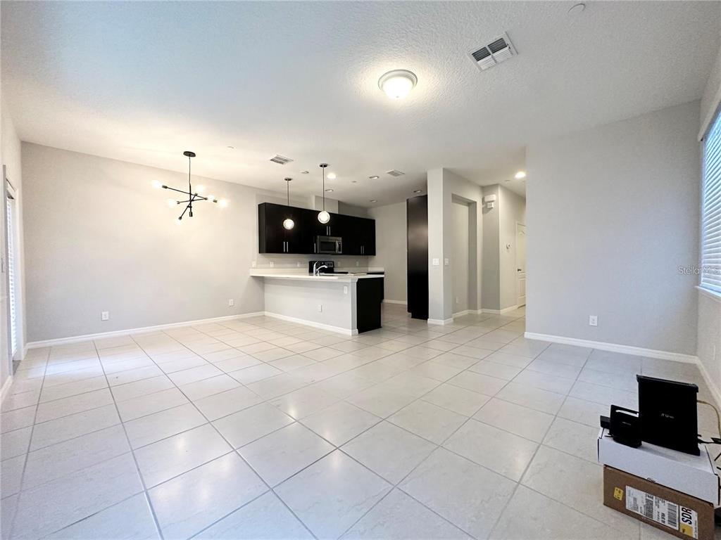 122 Zamora Place Oviedo, FL 32765 - Photo 7 of 23 a view of a electric appliances in kitchen and empty room with wooden floor