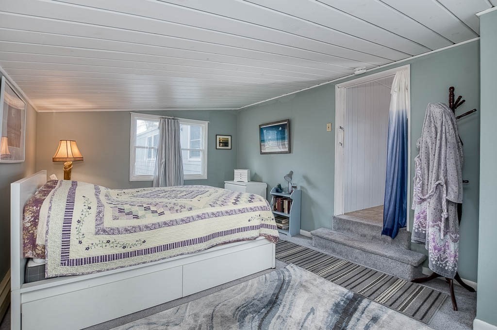 5 Timber Lane Wareham, MA 02571 - Photo 25 of 31 a spacious bedroom with a bed and a chandelier