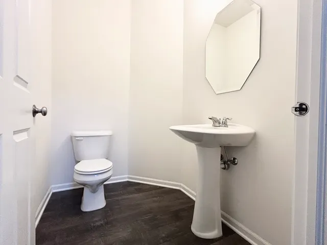 a bathroom with a sink toilet and a mirror