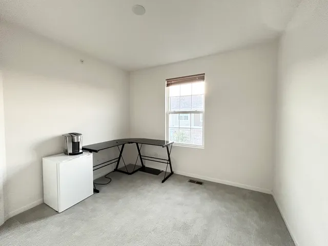 a room that has a bed and a dresser