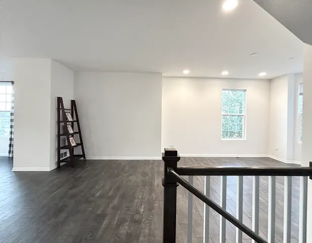 a view of entryway with wooden floor and stairs