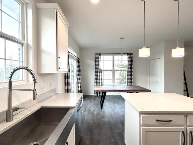 a view of a kitchen with a sink and window