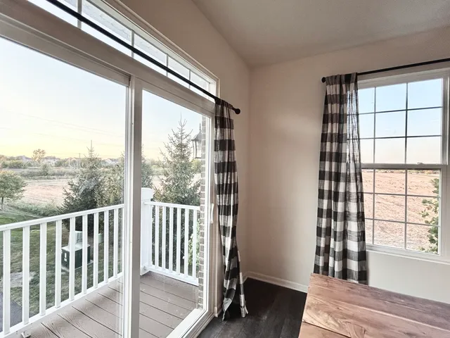 a view of a room with wooden floor and windows