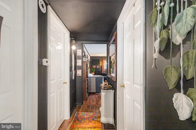 a view of a hallway with furniture and floor to ceiling window