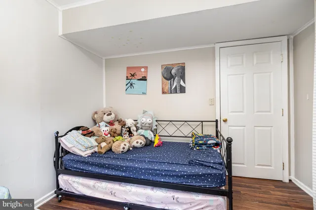 a bed room with furniture and wooden floor
