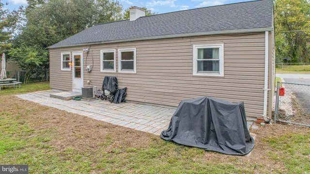 a view of a house with a yard and sitting area