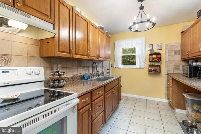a kitchen with stainless steel appliances a stove sink and cabinets