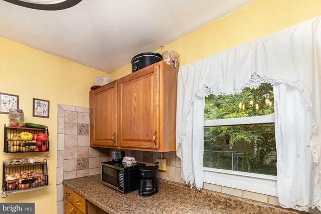 a kitchen with stainless steel appliances a counter top space and a window