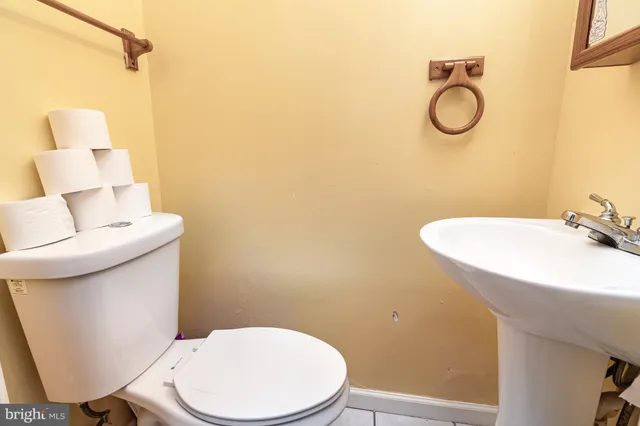 a white toilet sitting next to a bathroom sink