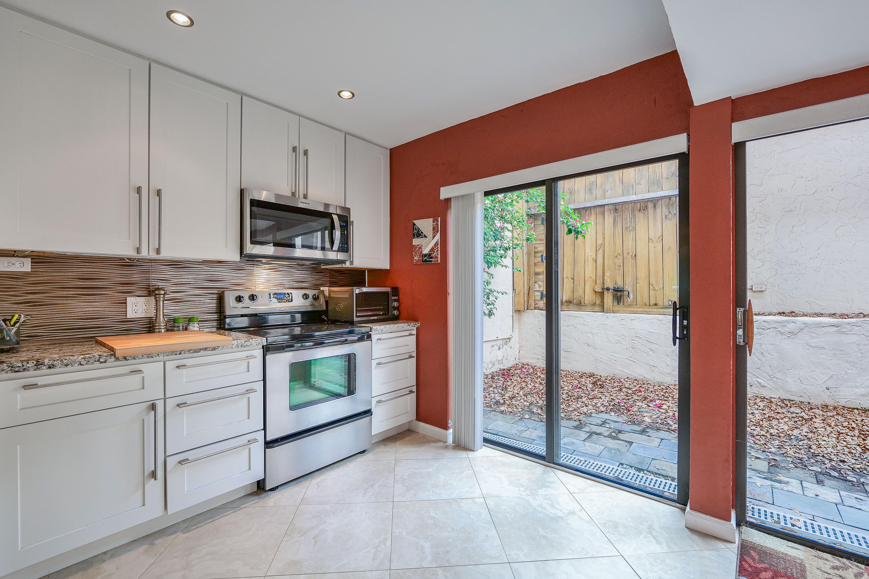 3425 Lime Hill Road, Unit 169 Lauderhill, FL 33319 - Photo 13 of 51 a kitchen with stainless steel appliances granite countertop a stove a sink and a refrigerator