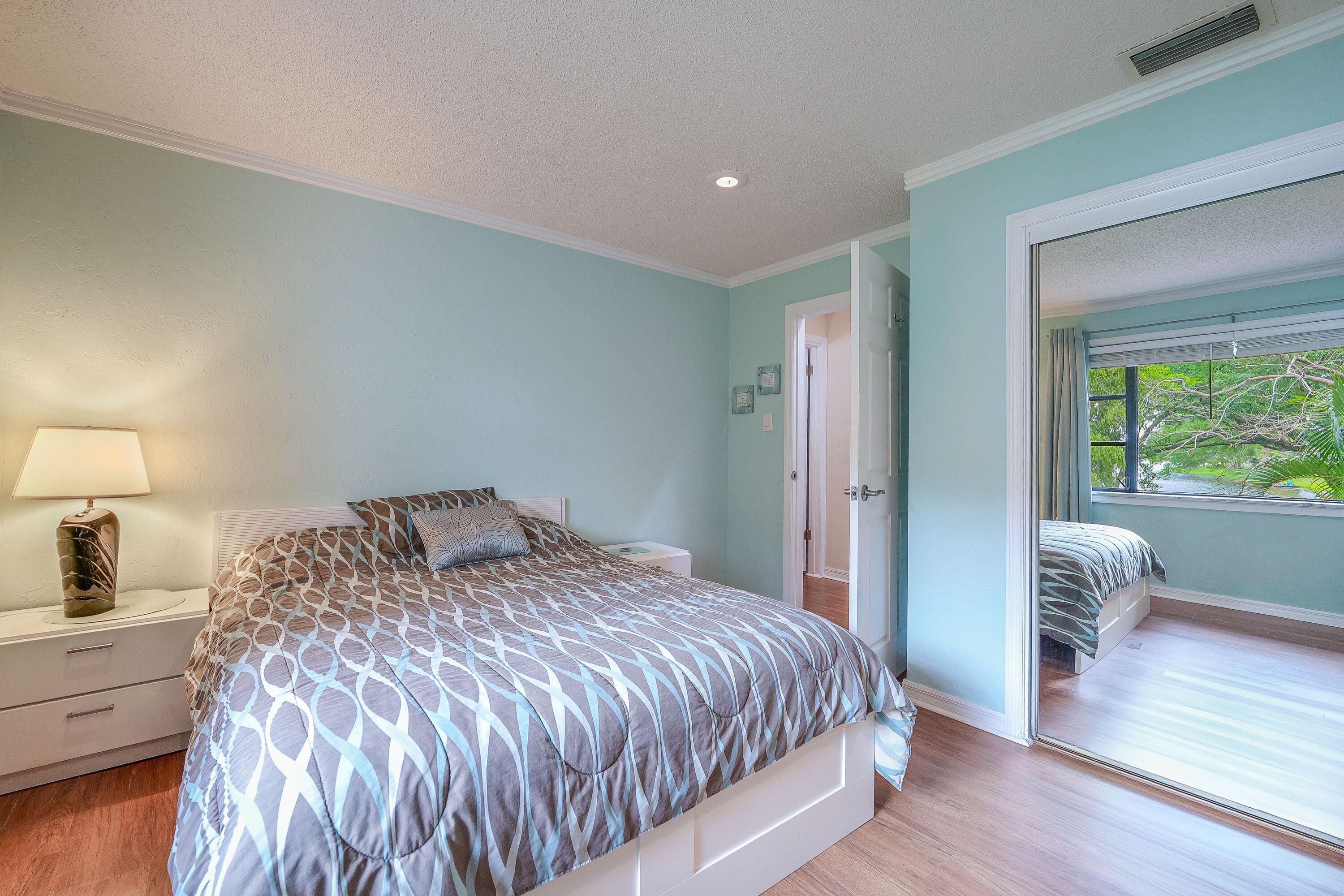 3425 Lime Hill Road, Unit 169 Lauderhill, FL 33319 - Photo 22 of 51 a bedroom with a bed and a large window