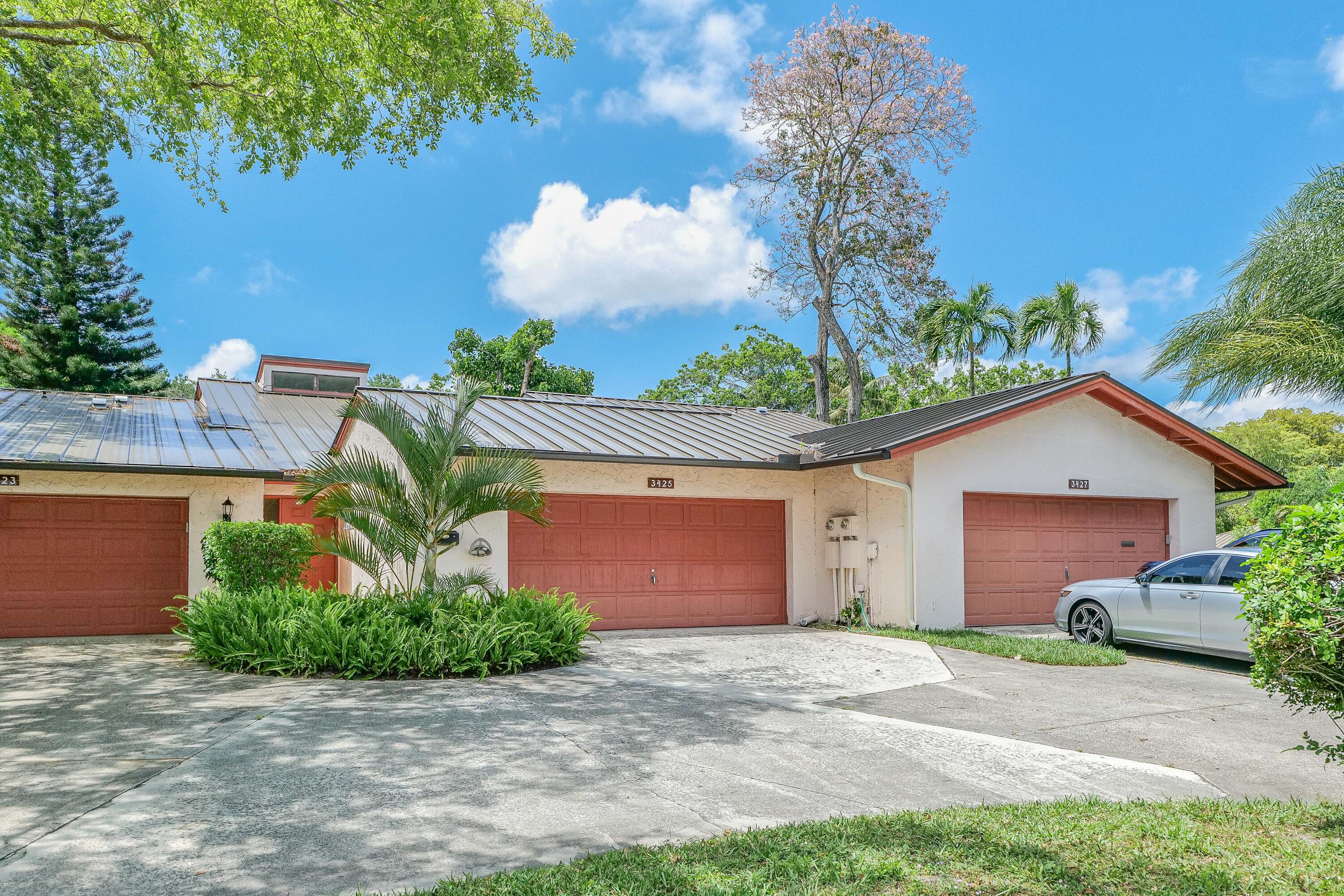3425 Lime Hill Road, Unit 169 Lauderhill, FL 33319 - Photo 4 of 51 a front view of a house with a yard and garage
