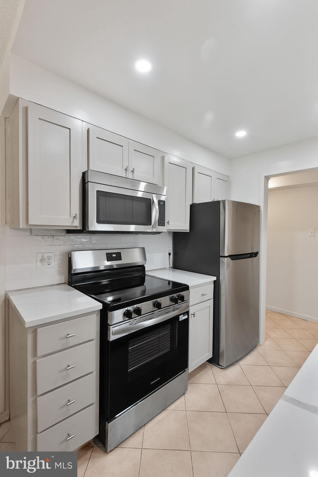11600 Stoneview Square, Unit 60/2B Reston, VA 20191 - Photo 15 of 27 a kitchen with cabinets stainless steel appliances and a counter space