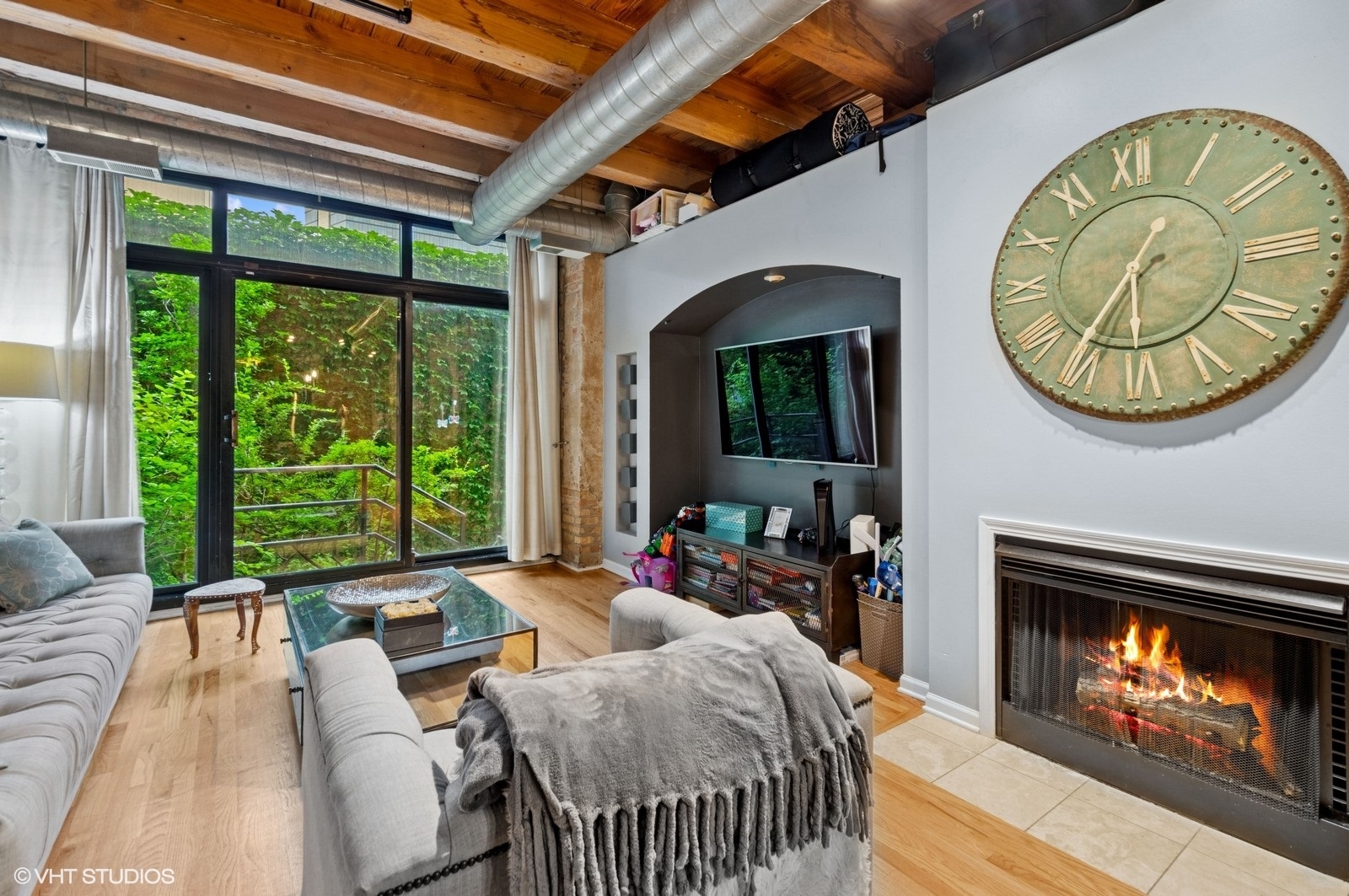 520 West Huron Street, Unit 109 Chicago, IL 60654 - Photo 5 of 14 a living room with furniture a large window and a fireplace