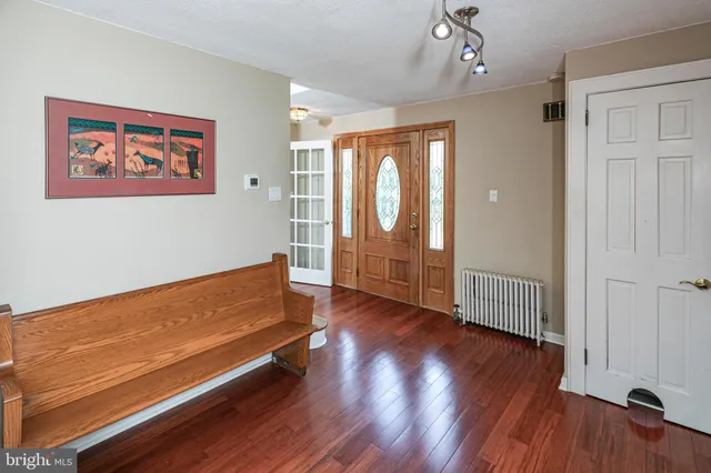 a living room with furniture and a book shelf